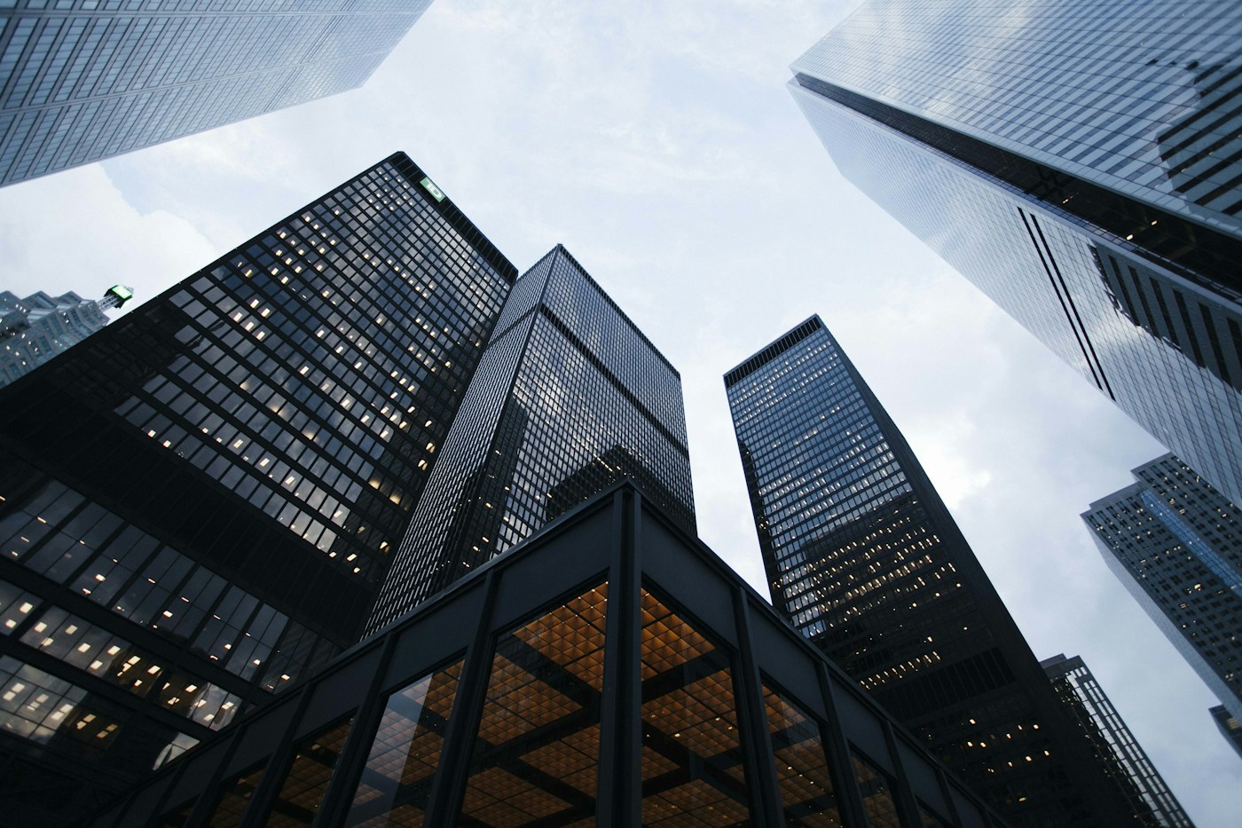 Looking upward between modern glass buildings